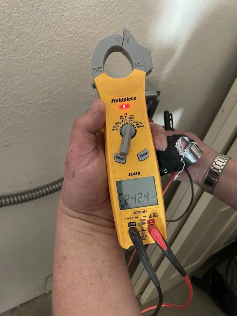 Voltage testing with clamp meter during Recessed Lighting Installation in Todd Creek